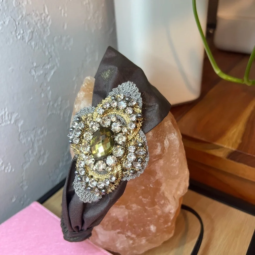 Headband, sparkling fabric and stunning brooch